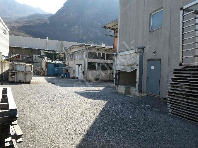 Capannone industriale ad uso produttivo con area esterna e porzione di parcheggio esterno in Valmadrera