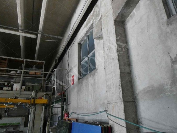 Capannone industriale ad uso produttivo con area esterna e porzione di parcheggio esterno in Valmadrera